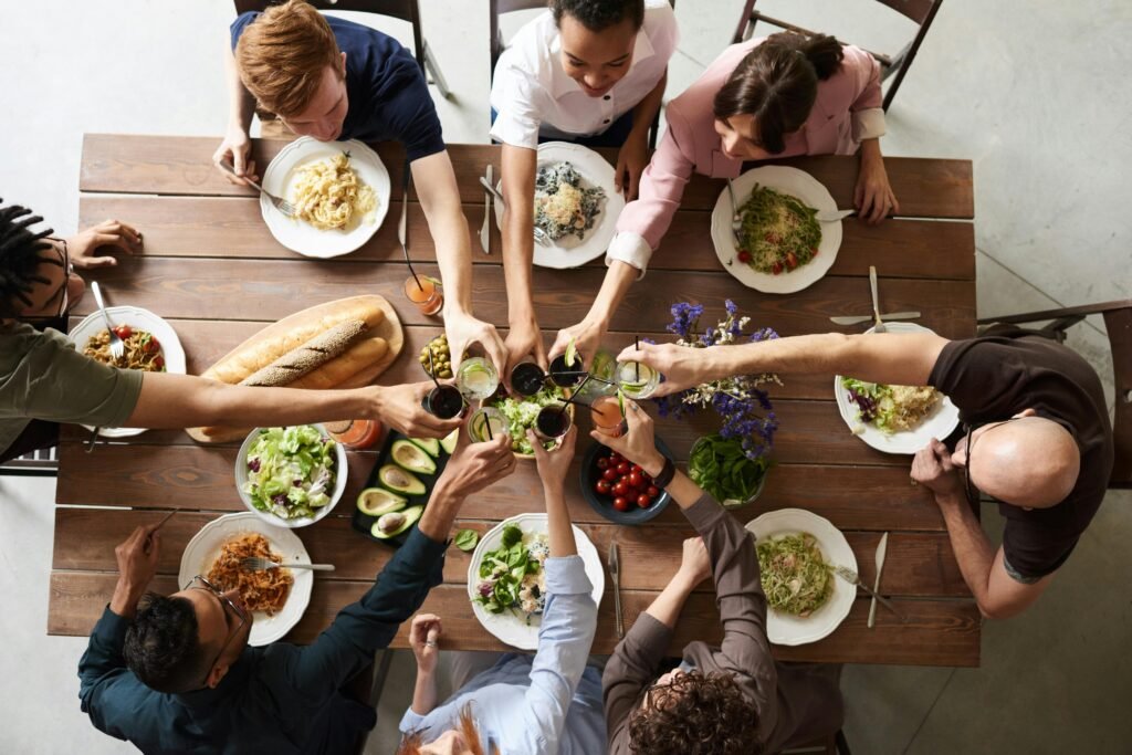 Holiday Dinner Essentials A vibrant group cheers over a delicious meal, showcasing friendship and togetherness.